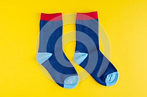 Cotton kids socks composition on yellow background