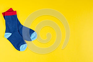 Cotton kids socks composition on yellow background