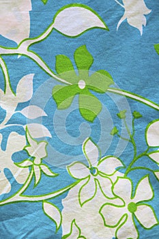 Cotton material with leaf and flower patterns.