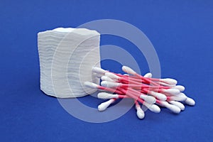 Cotton pads and cotton buds lie on a blue background.