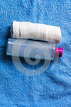 Cotton pads and plastic bottle with liquid and bubbles