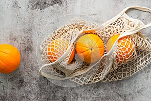 Cotton reusable bag with fresh oranges