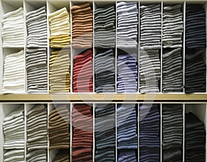 Cotton T-shirt folded neatly in the showroom,Colorful clothes folded in the cabinet,Colorful clothes neatly dressed,Shelves and