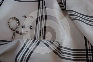 Cotton texture fabric or cloth textile with cage and silver earrings bracelet