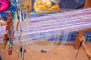 Cotton weaving on manual loom. Thai cotton handmade. Homespun fabric process. The process of fabric