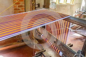 Cotton weaving on a traditional wooden handloom