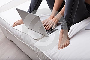 Couch, bare feet, laptop, female hands, keyboard, white sofa, re