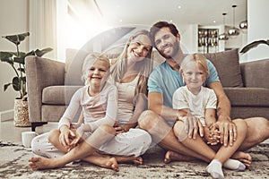 Couch, happy family and parents with children on living room floor and relax by sofa together in the morning. Love, care
