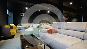 Couches and sofas displayed for sale in showroom at furniture store