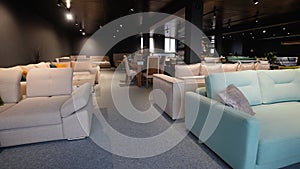 Couches and sofas displayed for sale in showroom at furniture store