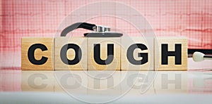 Cough word on wooden cubes. Conceptually for healthcare, hospital, clinic and medical business