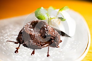 Coulant. Molten chocolate cake is a popular dessert that combines the elements of a flourless chocolate cake and a soufflé.