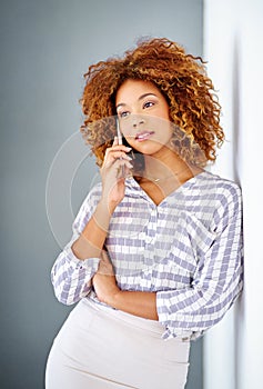 This could be the next big opportunity. Studio shot of a young woman using her cellphone against a grey background.