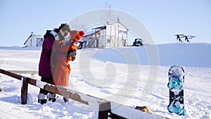 Coulple dating in mountain resort at sunny day. Winter, sport, holidays, relationship, love, xmas, lifestyle concept