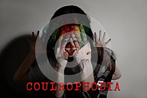 Coulrophobia. Double exposure of scared woman and clown