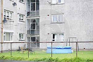 Council housing flats and water paddling inflatable pool in garden