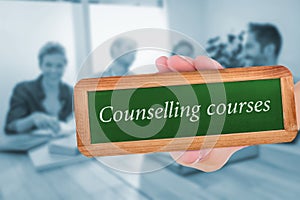 Counselling courses against group of colleagues reading books