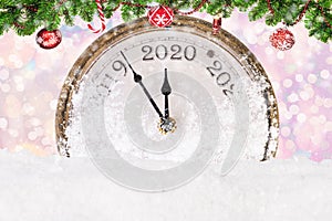 Countdown to midnight. The hands of the retro clock indicate the approach of the new year 2020