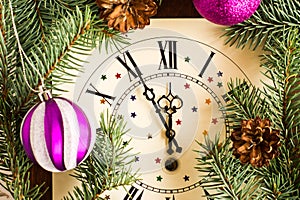 Countdown to midnight. retro watches with spruce branches, cones and Christmas balls. happy new concept of the year