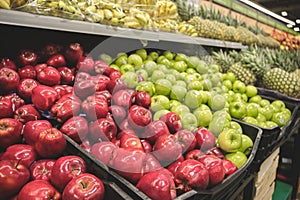 The counter with fresh fruit and vegetables in the supermarket.