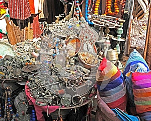 Counter in Morocco street vendor of old things - junk with old used jewelry, jewelry, metal and ceramic crockery and clothing