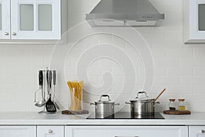 Counter with set of dishware and utensils in kitchen interior