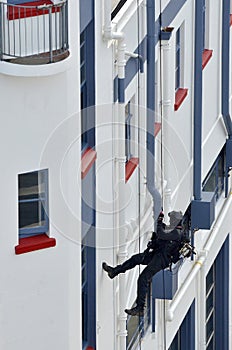 Counter-terrorism police officer abseiling a building