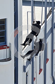 Counter-terrorism police officers abseiling a building photo