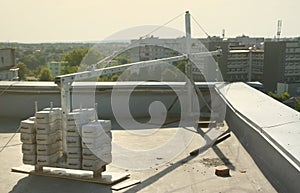 Counter weight or weight balance concrete blocks or bricks as part of suspended wire rope platform for facade works on