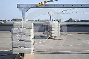 Counter weight or weight balance concrete blocks or bricks as part of suspended wire rope platform for facade works on high