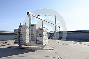 Counter weight or weight balance concrete blocks or bricks as part of suspended wire rope platform for facade works on high