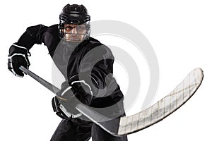 Counterattack. Professional male hockey player training in special uniform with helmet isolated over white background