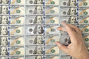 Counterfeiter forges banknotes. Fake concept. Fake money American dollars. search for counterfeit bills. US dollars on background photo