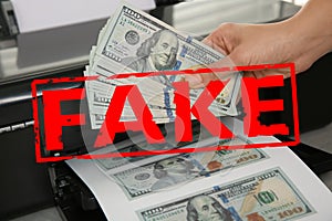 Counterfeiter printing fake dollar banknotes, closeup