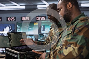 Counterintelligence colleagues combating terrorism using detection system on laptop