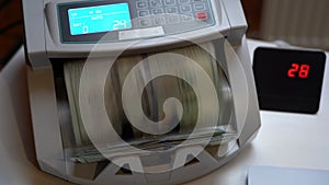 Counting machine for banknotes. Ukrainian Banknote counting machine. American money in a counting machine. Currency conversion.