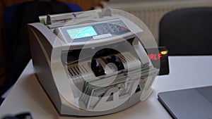 Counting machine for banknotes. Ukrainian Banknote counting machine. American money in a counting machine. Currency conversion.