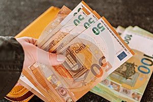 Counting money.Banknotes in hand. banknotes in a yellow leather wallet. Earnings in the Eurozone.