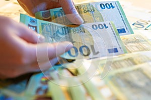 counting money.Hands collecting money.Euro currency inflation.100 euro banknote.Euro currency exchange rate in Europe