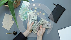 Counting money. Hands count pile of US dollars banknotes. Concept of success, investments, finance. Businesswoman counting company