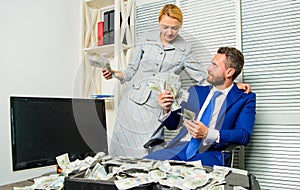 Counting money profit. Man businessman and woman secretary with pile dollar banknotes. Profit and richness concept