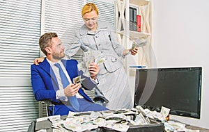 Counting money profit. Man businessman and woman secretary with pile dollar banknotes. Profit and richness concept