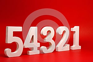 Counting numbers  1 2 3 4 5  white number wooden on Red Background with Copy Space - One Two Three Four Five