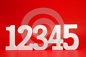 Counting numbers  1 2 3 4 5  white number wooden on Red Background with Copy Space - One Two Three Four Five