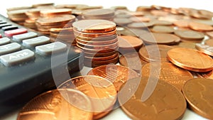 Counting the Pennies - Stacks of Pennies Beside a Calculator