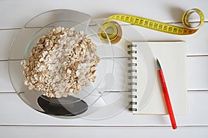 Counting and recording the amount of carbohydrates, calories, proteins and fats in food. Flakes from four cereals on kitchen