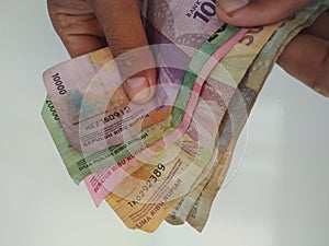 Counting the rupiah which is a means of payment for the Indonesian state. photo