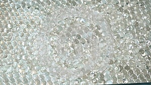 Countless hydrogel beads captured up close, each one a tiny lens magnifying the complexities of their simple, yet