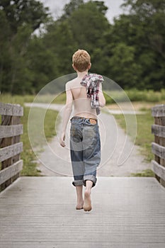 Country boy on a wooden bridge