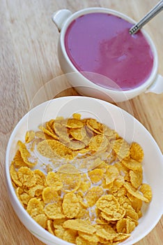 A country breakfast with blueberry yogurt, milk and cornflakes